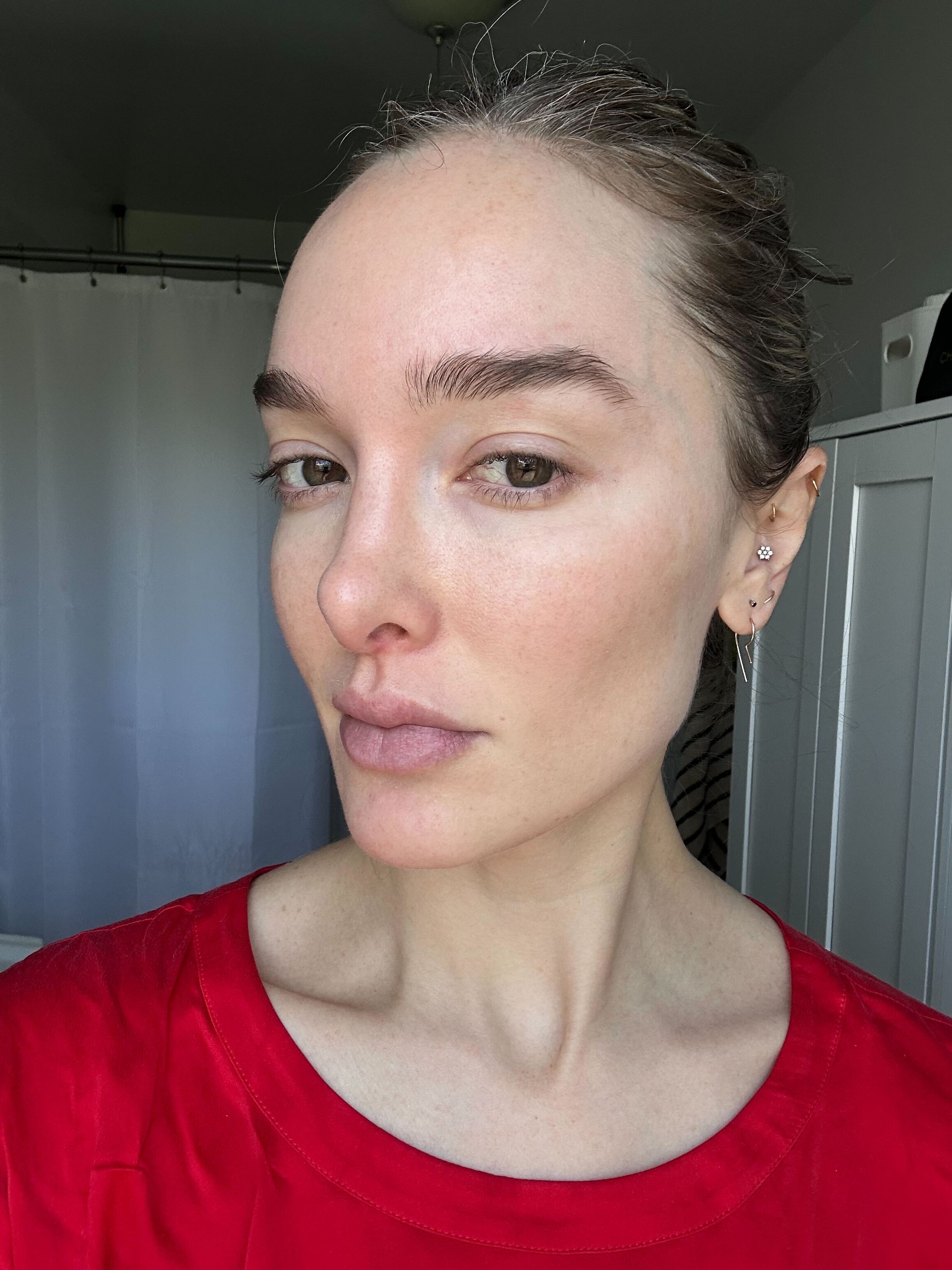 A girl with a red shirt before applying SPF.