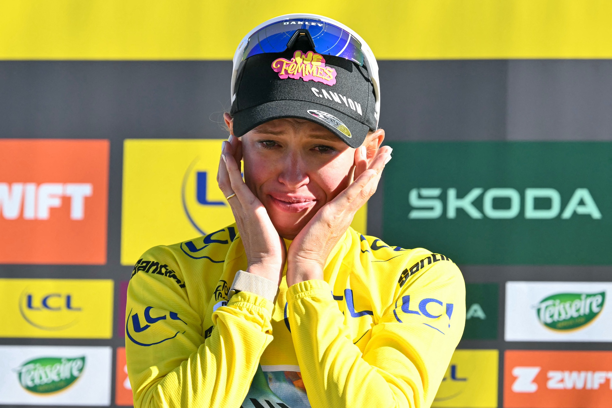 Kasia Niewiadoma-Phinney (Canyon-SRAM) shifts into the overall leader's yellow jersey after the 7th stage of the fifth edition of the Tour de France Femmes (Photo by NICOLAS TUCAT / AFP)
