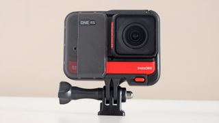 The Insta360 One RS action cam on a beige background