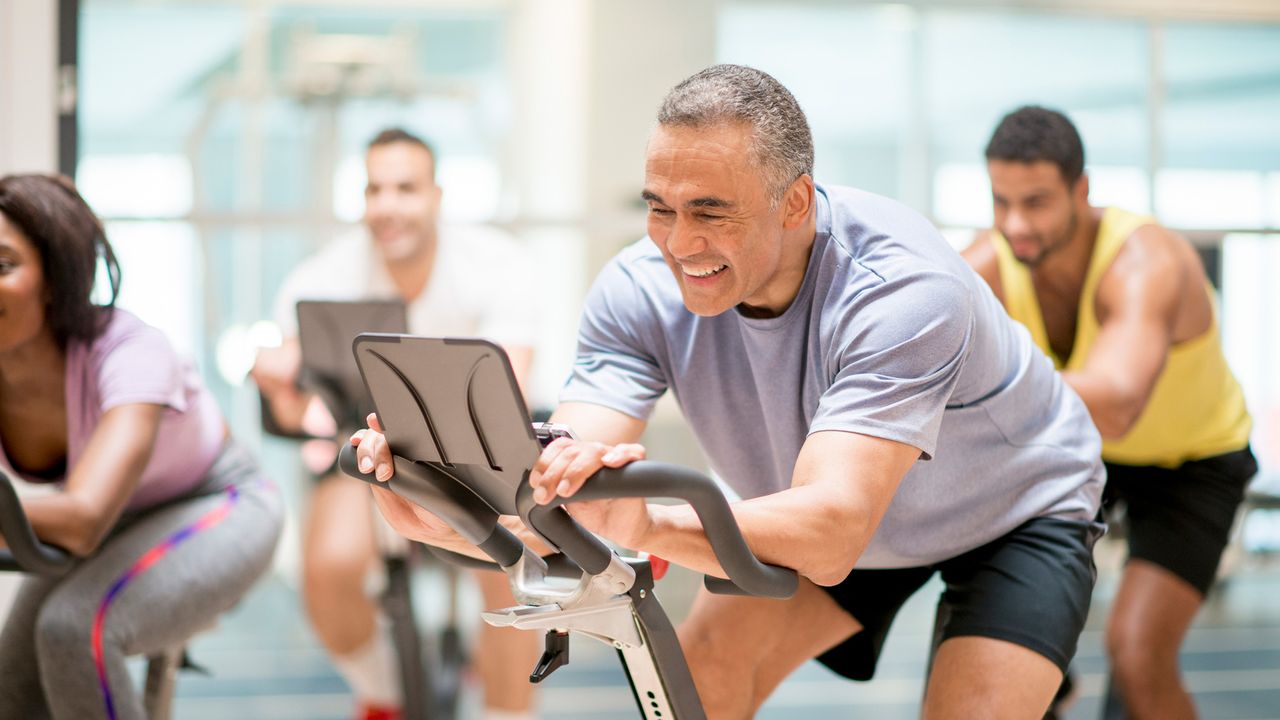 Man doing a weight loss spin class