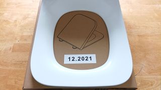Square shaped toilet seat on packaging
