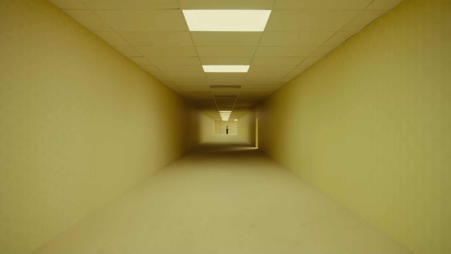 A24's The Backrooms movie trailer screenshot showing a long corridor with yellow wallpaper