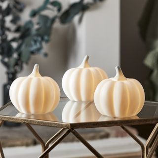 group of three light pumpkins on a coffee table in a living room