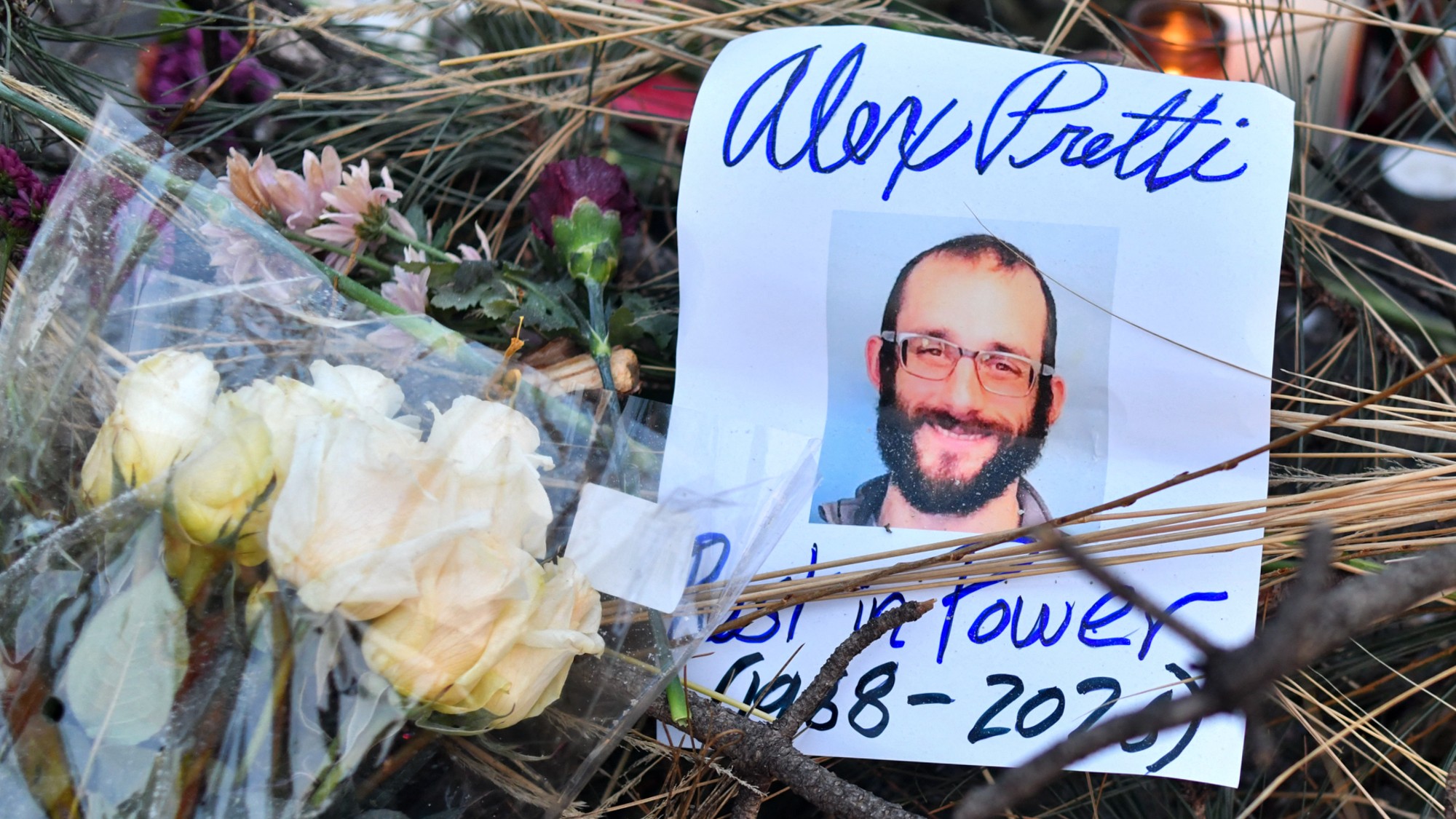 Flowers are left at a makeshift memorial for Alex Pretti in Minneapolis