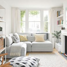 Neutral living room with grey sofa and yellow accent cushions
