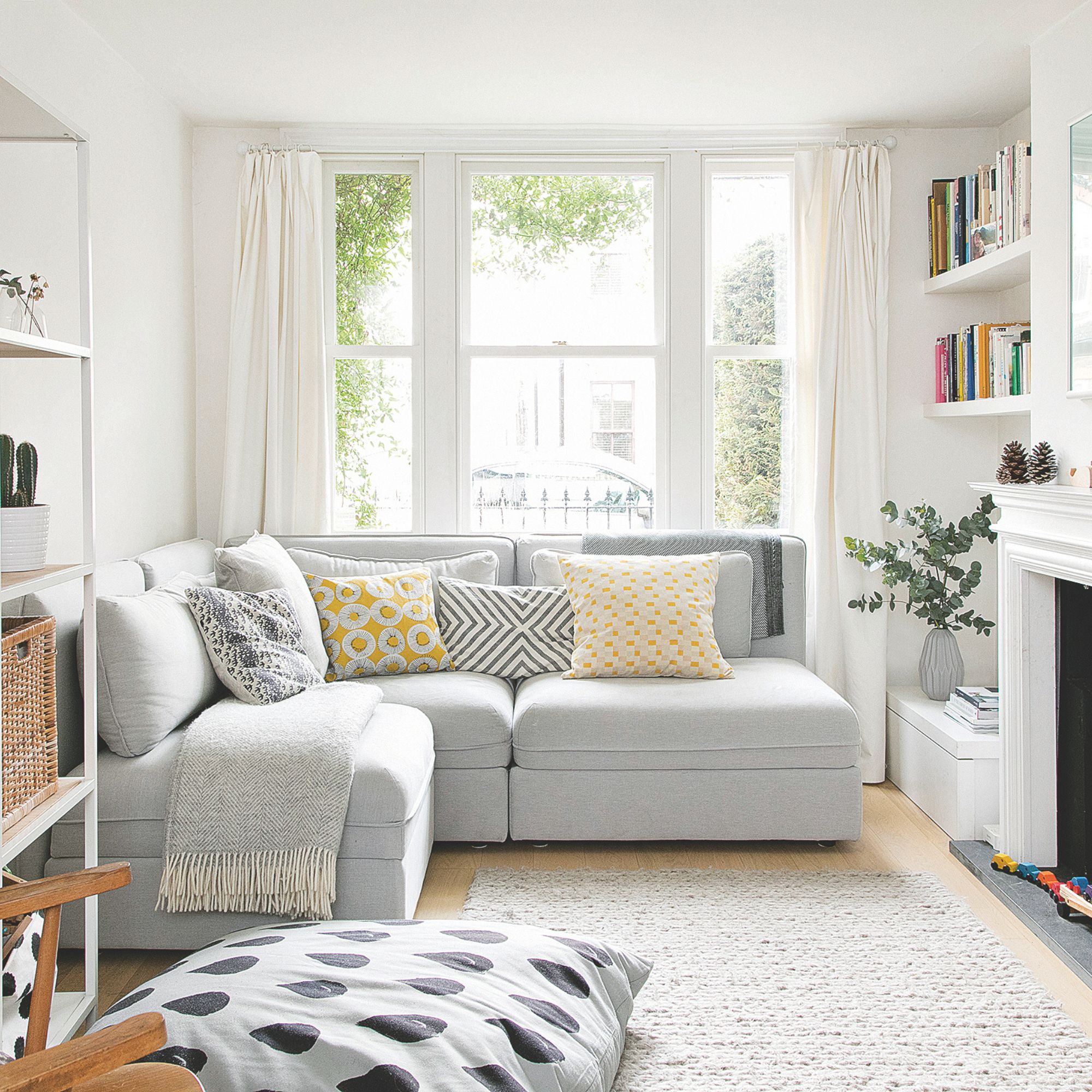 Neutral living room with grey sofa and yellow accent cushions