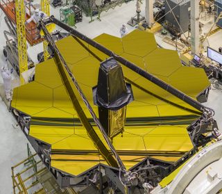 The golden mirrors of NASA's Names Webb Space Telescope are seen in this image inside the clean room at the space agency's Goddard Space Flight Center. The space telescope is undergoing testing ahead of its 2018 launch.