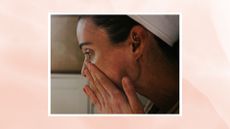 A close up of a woman wearing a towelled headband touching her nose and cheeks with her hands/ in a pink watercolour paint-style template