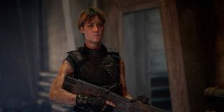 Mackenzie Davis as Grace holding gun in Terminator: Dark Fate