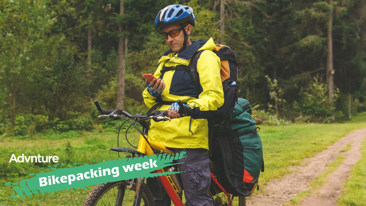 Bikepacker checking phone during ride