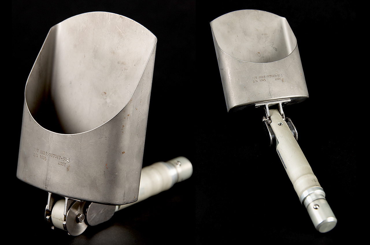 two views of a small, foldable silver shovel against a black background.