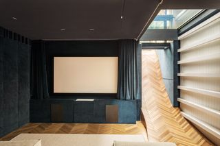 cinema room and slide in suburban House by SPPARC