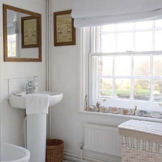 bathroom with white wall and laundry bag