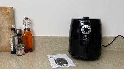 Magic Bullet Air Fryer on a counter with its user manual