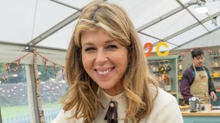 Kate Garraway wearing a cream top and making in the Bake Off tent