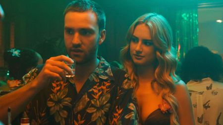 Stephen and Lucy drink at a party