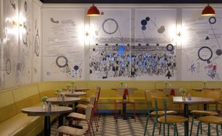 The new complex's ground floor cafe features mural depicting the history of cinema