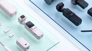 Two DJI Pocket 2 cameras resting on glass surrounded by accessories