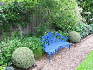 blue bench on pale gravel