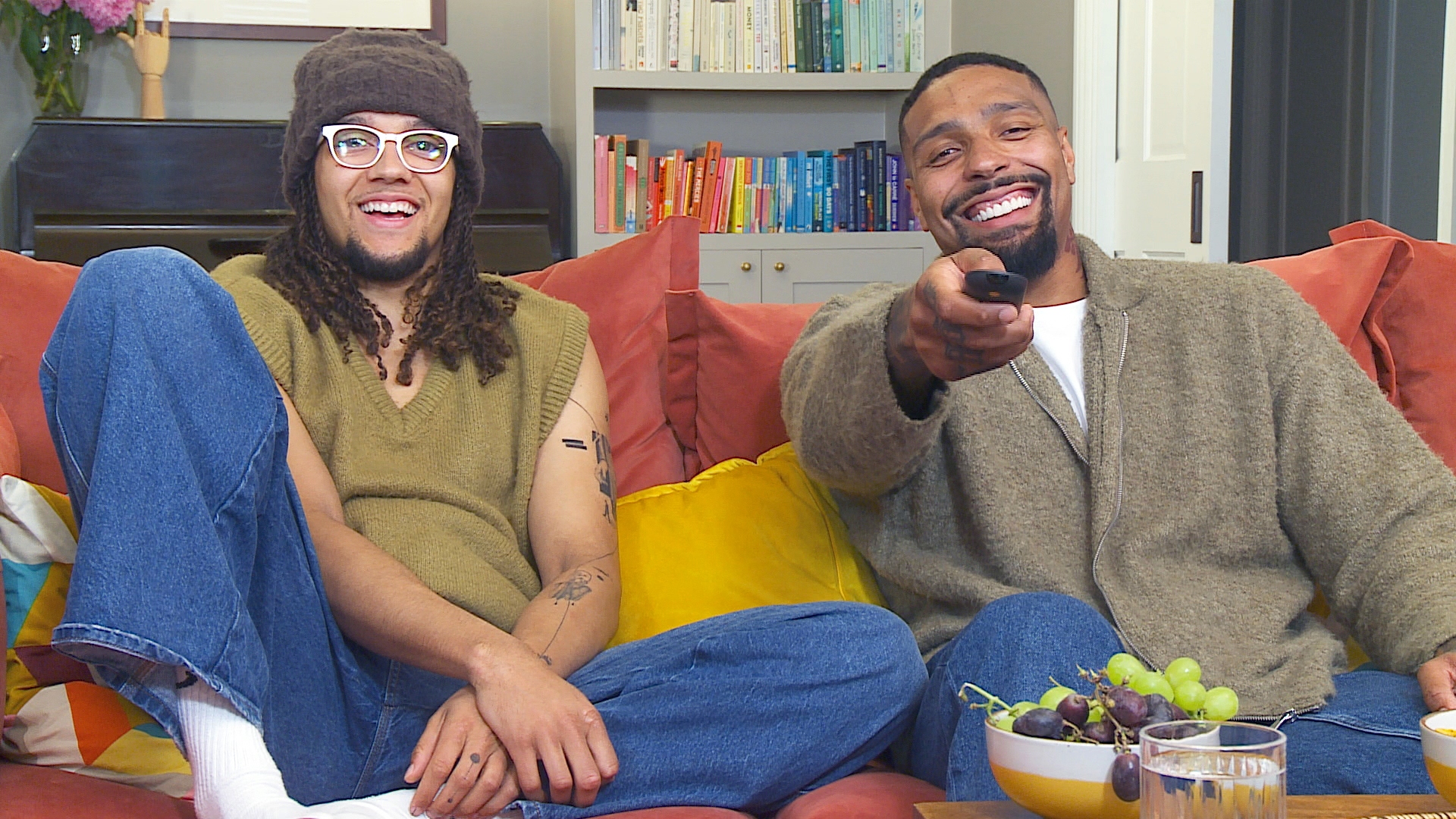Perri and Jordan on their sofa laughing for Celebrity Gogglebox 2025