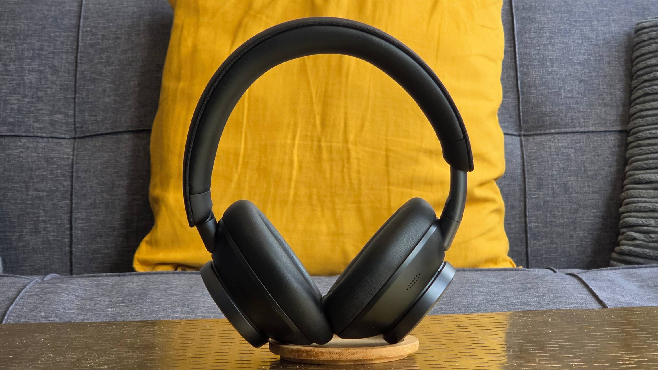 The Earfun Wave Pro X stood up on a sofa.