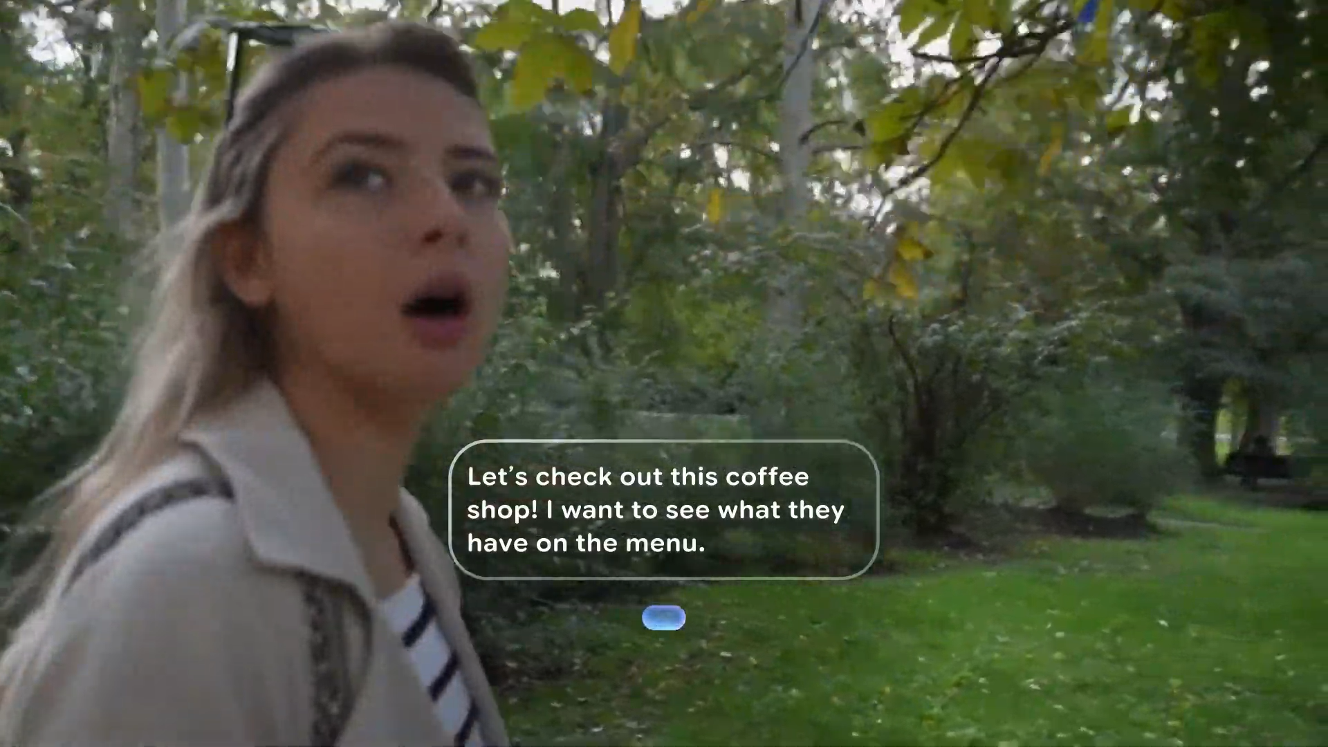 A still from an Android XR example video of how the software will work on smart glasses, showing the wearer's words about a coffee shop being translated into Spanish for the woman in front of them.