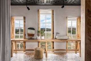 Light wood long table with stone skink and matching wooden shutters