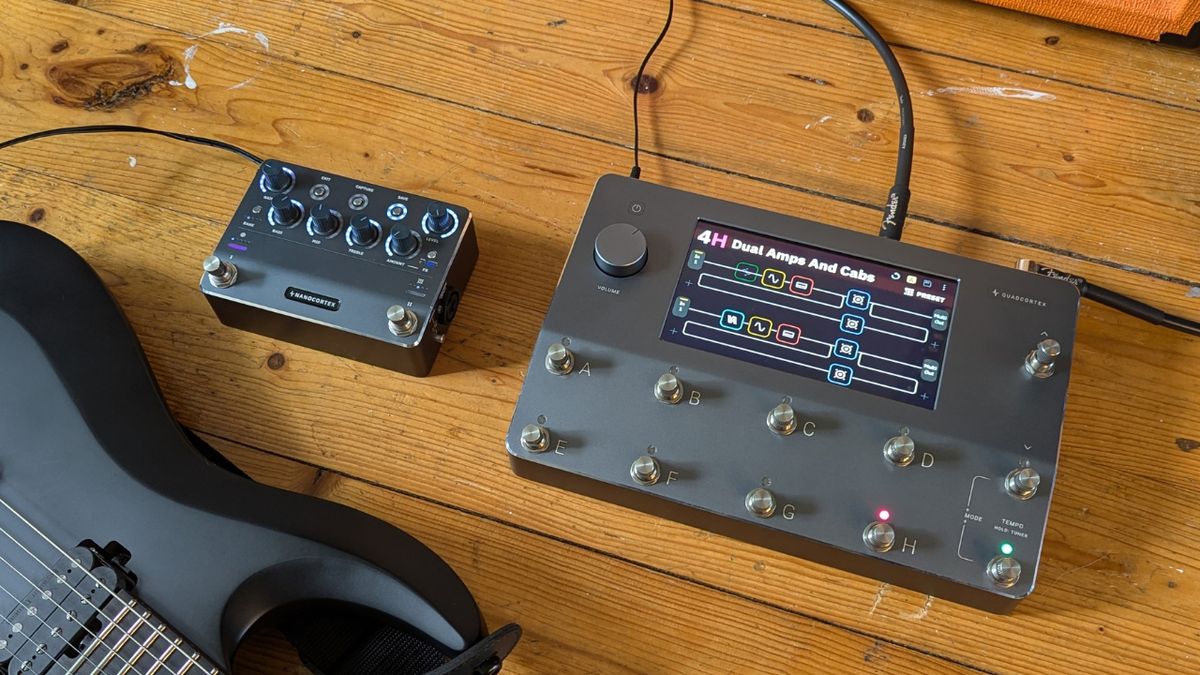 A Neural DSP Quad Cortex and Nano Cortex on a wooden floor with an electric guitar