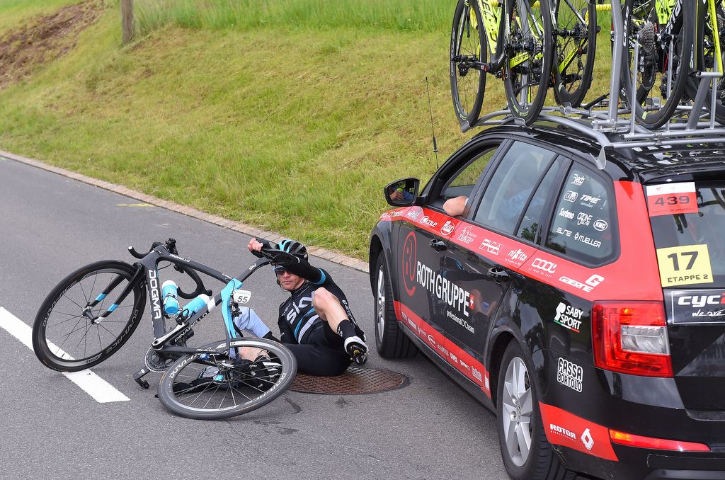 Vasil Kiryienka comes close to being run over by the Roth Gruppe team car having gotten himself tangled up