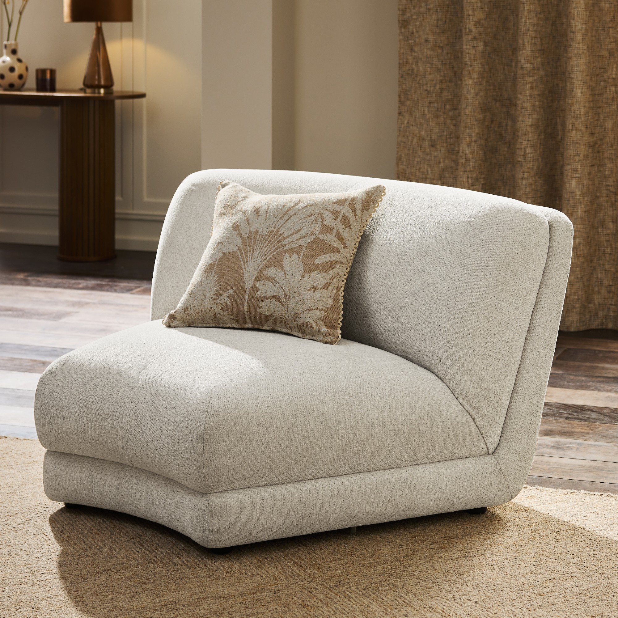 A single module of Next's Addison modular curved sofa in oyster chenille in a large living room