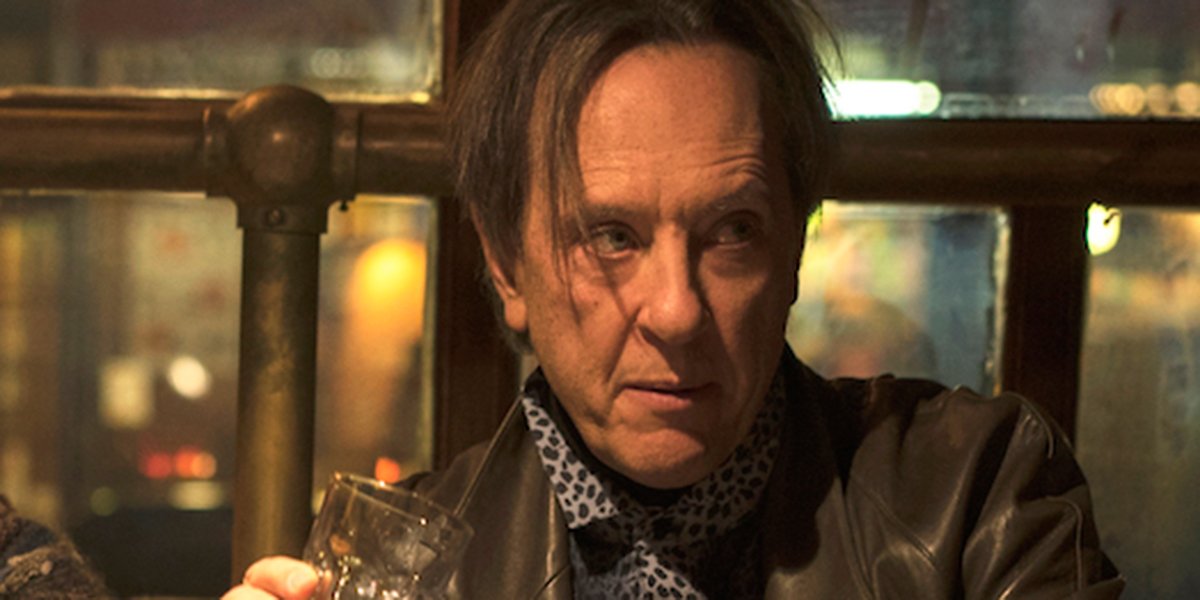 Richard E. Grant enjoying a drink in Can You Ever Forgive Me?