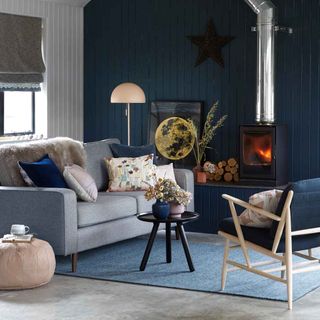 living room with dark navy blue wall and sofa