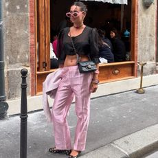 An image of @stylewithsoco wearing silk taffeta trousers, one of the biggest summer trouser trends of 2026. 
