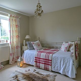 guest bedroom with bed with bedside table and lamp