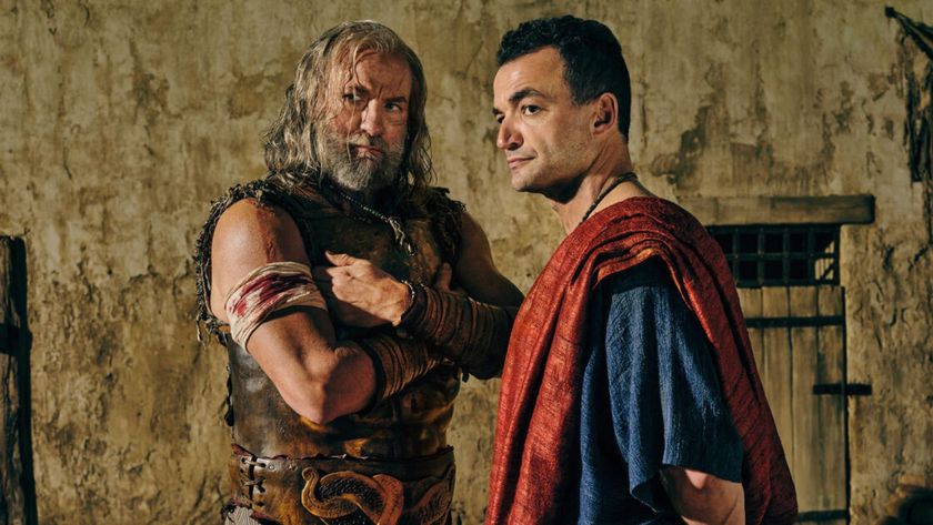 Korris and Ashur look at something offscreen