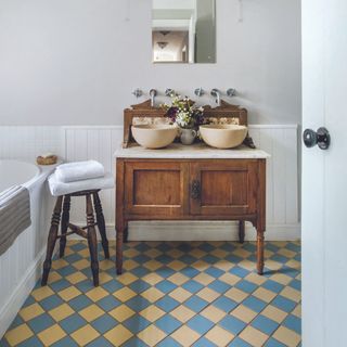 Bathroom with blue and yellow checkered flooring