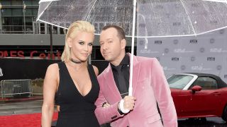 Jenny McCarthy and Donnie Wahlberg at the AMA Awards 2016, Donnie in a Pink suit, Jenny in a black dress.