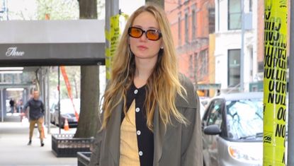 Jennifer Lawrence in New York City wearing the butter yellow trend in a t shirt with a button-up cardigan