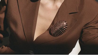 Model wears brown So-Le Studio brooch