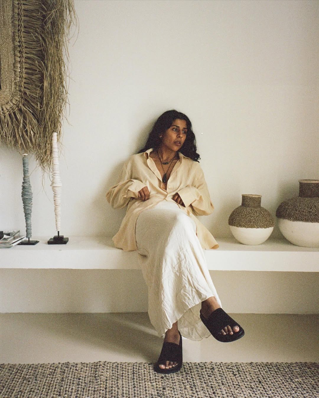 @monikh wearing a linen skirt, shirt and slides