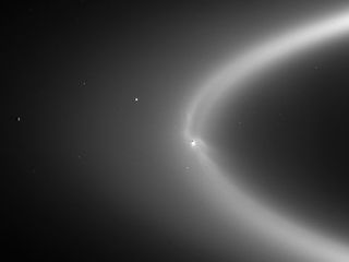 An image from Cassini that shows Enceladus in the haze of Saturn's E-ring.