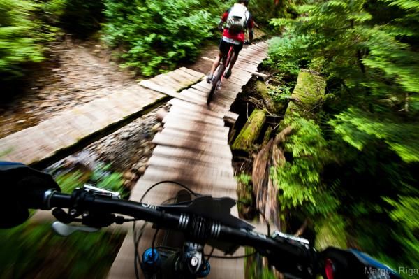 Riders cross a bridge