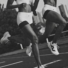 Two women running on a track