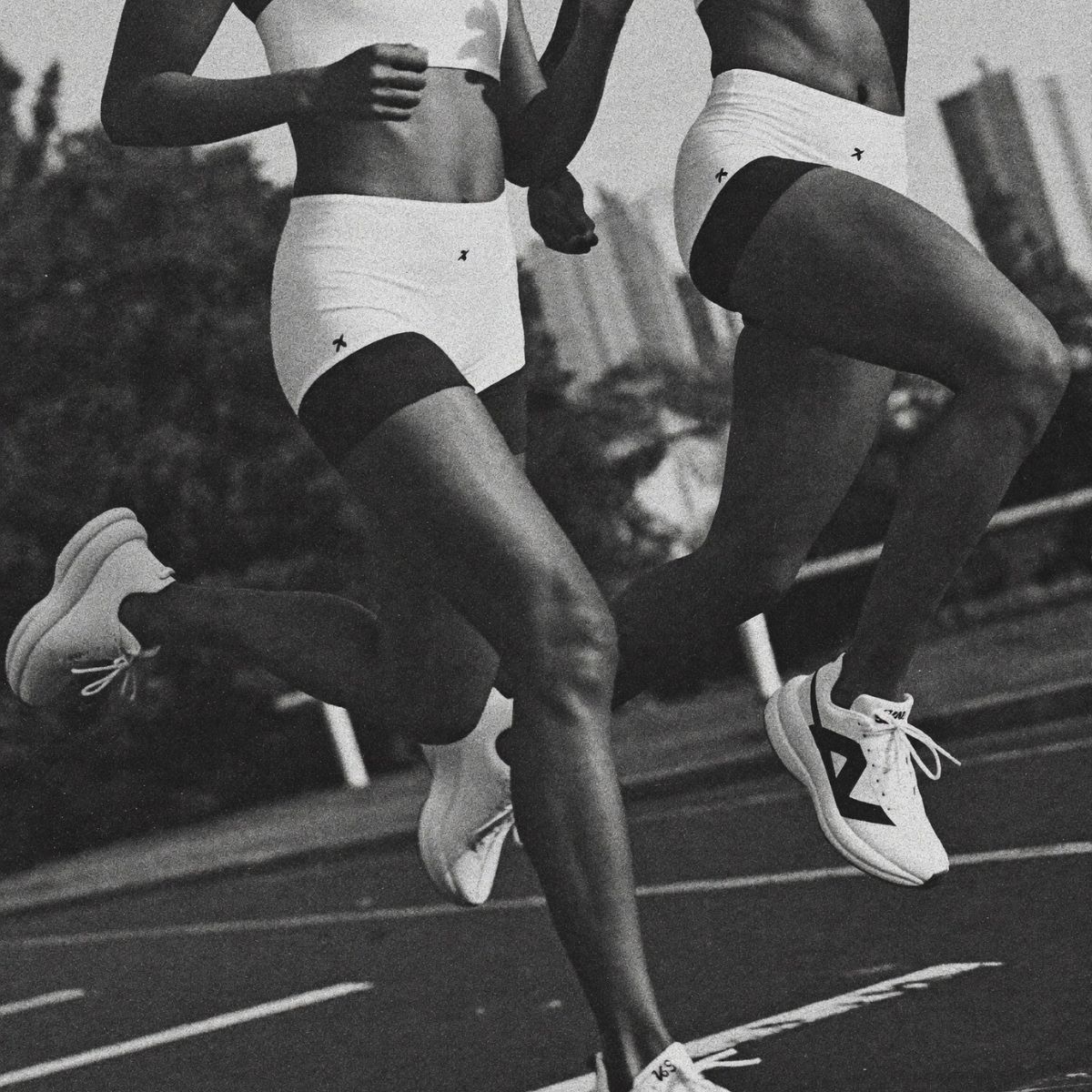 Two women running on a track