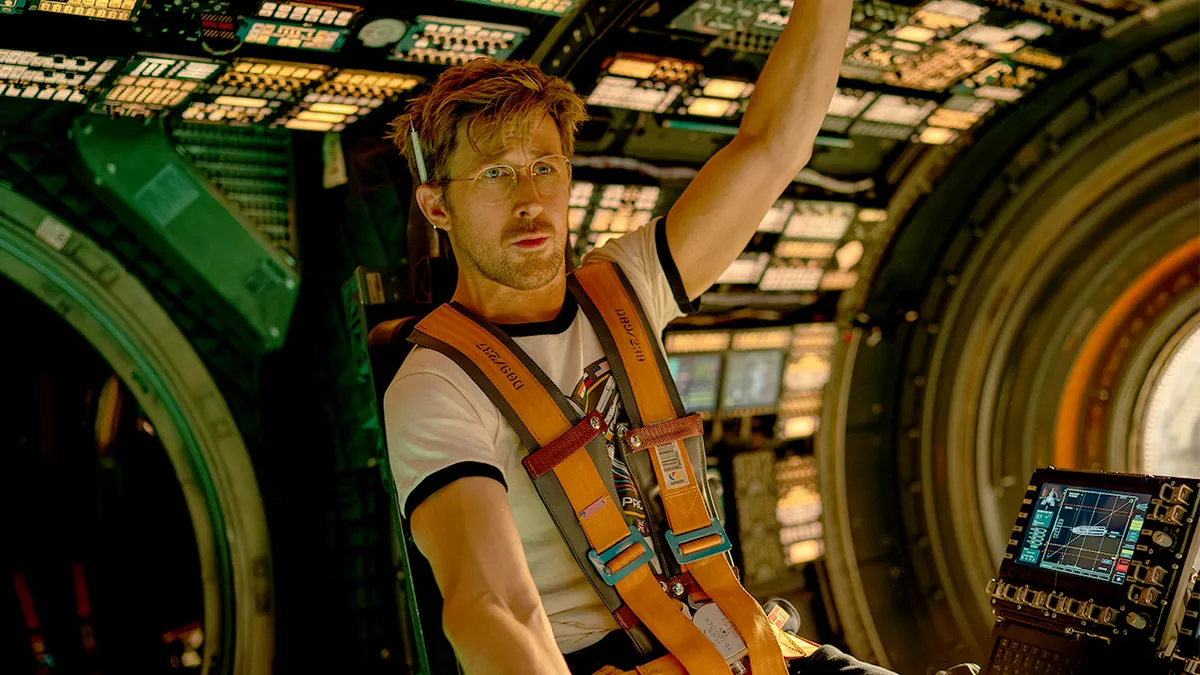 ryan gosling as grace strapped into the captain's chair and driving a rocketship in project hail mary