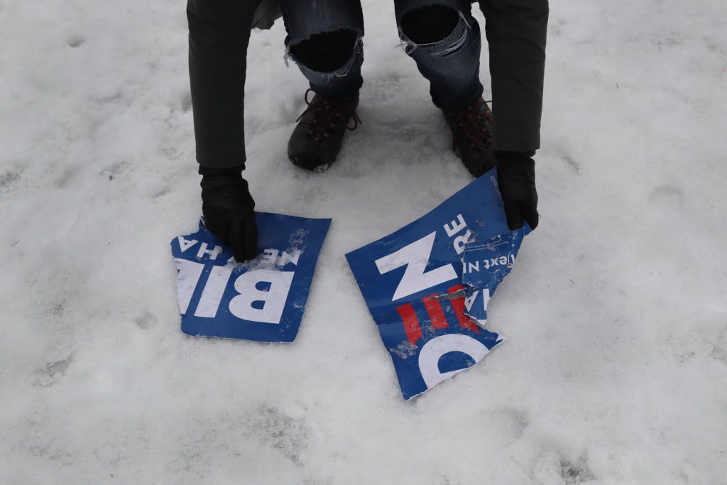 Crumpled Joe Biden sign on the ground.