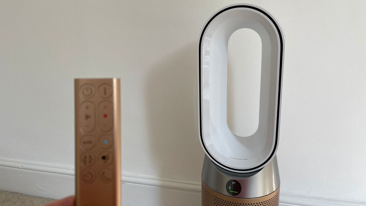 Dyson Hot + Cool Air Purifier with the remote in front of it