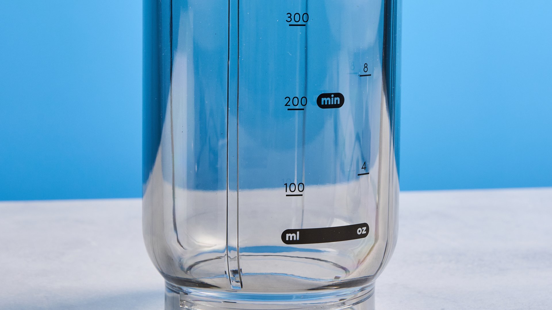 Nutribullet Flex blender photographed on a blue background