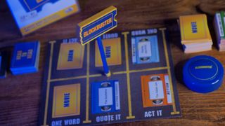 The Blockbuster game board with cards and the box sat on a wooden table
