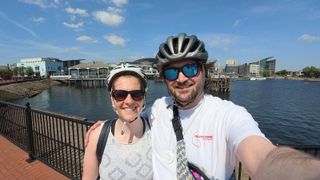 A selfie style photo of reviews editor Peter Wolinski and his partner, taken at a bayside on a sunny day. Taken on the Insta360 Go 3S.